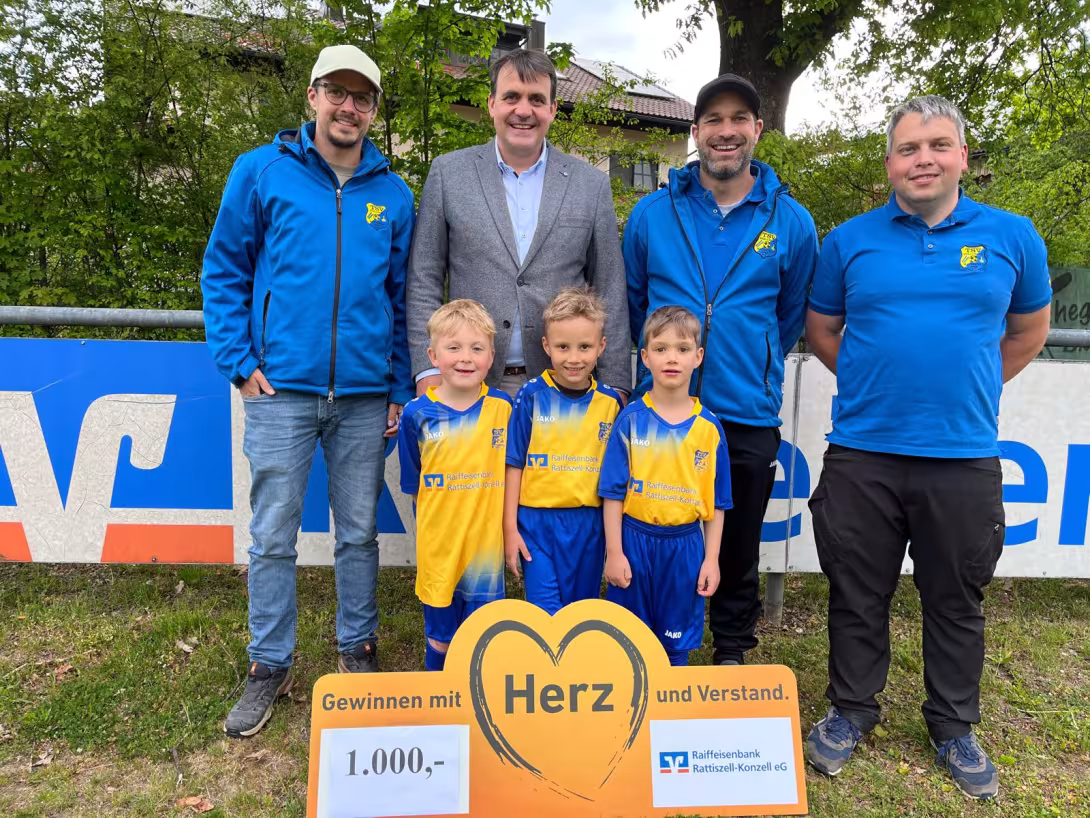 Trainer Josef Kienberger, Vorstand der Raiffeisenbank Rattiszell-Konzell eG Christian Stahl, Trainer Bastian Biendl, Jugendleiter Simon Stahl mit drei Spielern im neuen Trikotsatz